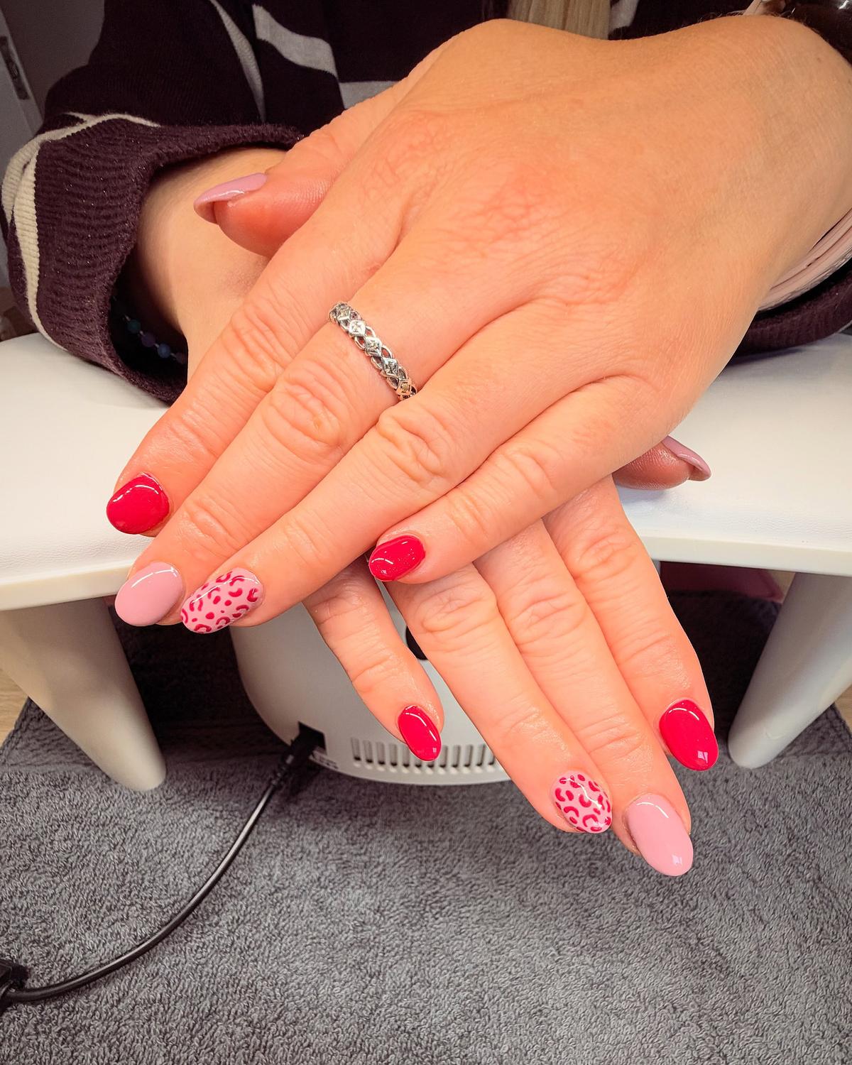 Hot-pink and soft-pink gel nails with pink leopard-print accent nails