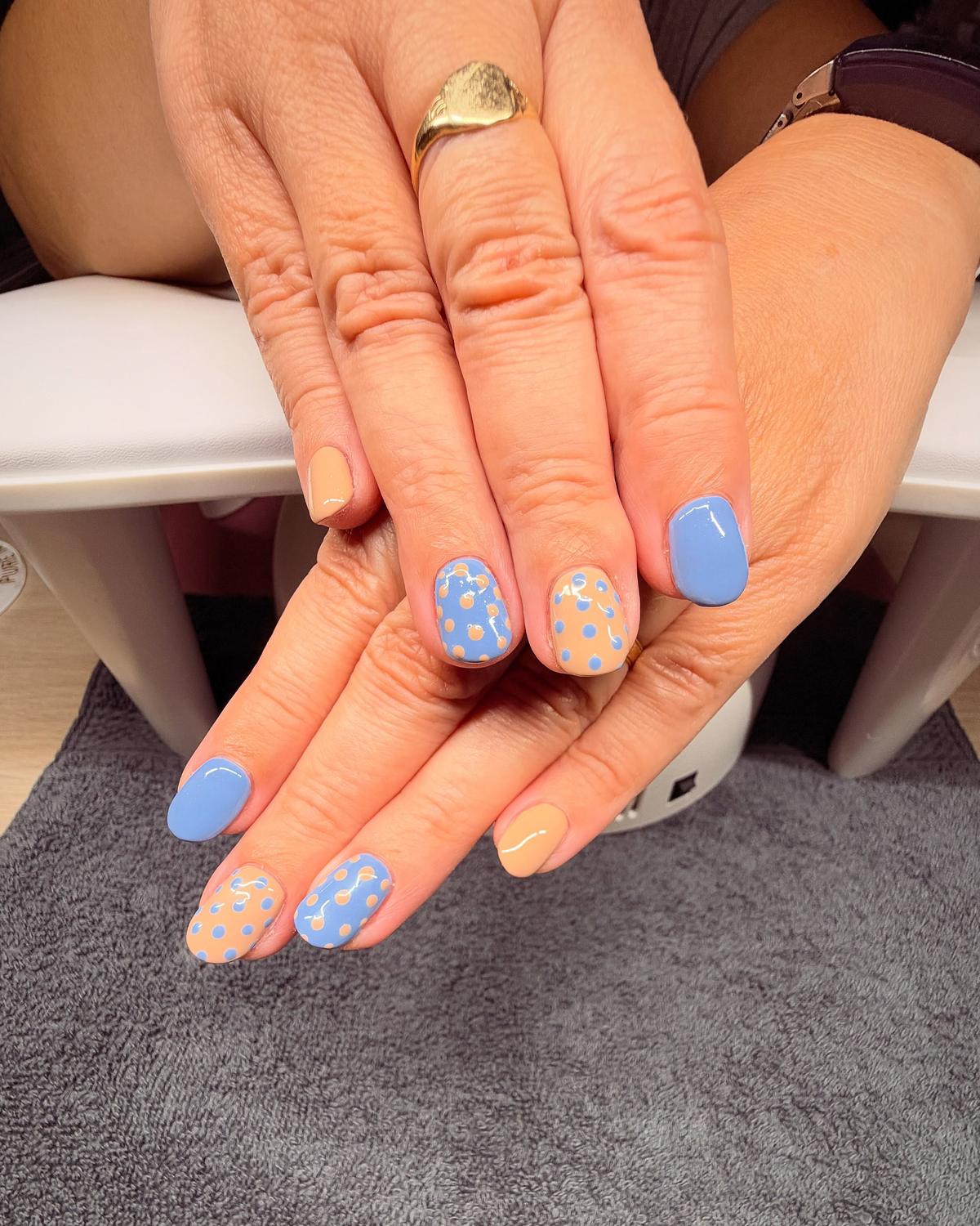Cornflower-blue and peach gel nails with polka-dot accent nails